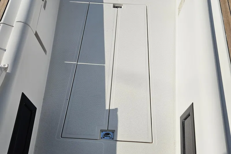 Slide: The Image of 2017 Elan E4 yacht deck with storage hatch and textured surface. - 39