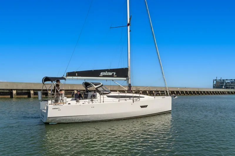 Slide: The Image of 2017 Elan E4 sailboat on calm water near a pier under clear blue sky. - 5