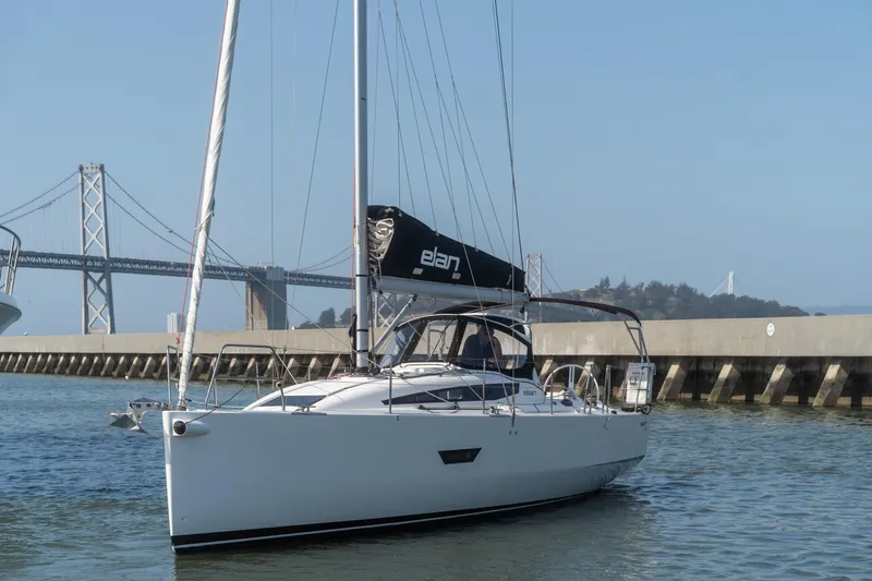 Slide: The Image of 2017 Elan E4 sailboat docked near a bridge on a sunny day. - 7