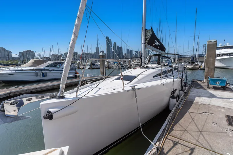 Slide: The Image of 2017 Elan E4 sailboat docked in marina with city skyline in background. - 8