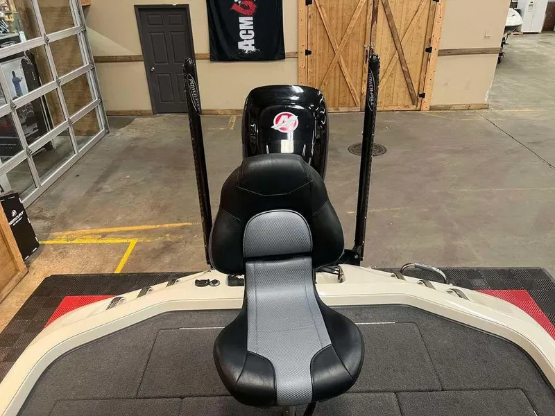 Slide: The Image of 2018 Ranger Z521C boat interior with black and gray seat in a garage setting. - 9