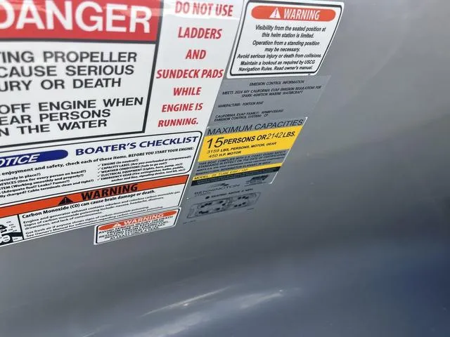 Slide: The Image of Safety and capacity labels on a 2024 Bennington 25 QFBWA boat, maximum 15 persons or 2,124 lbs. - 11
