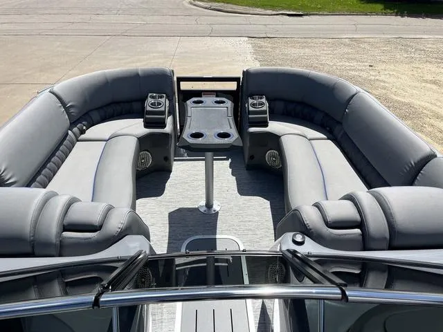 Slide: The Image of 2024 Bennington 25 QFBWA pontoon boat with luxurious seating and cup holders. - 13