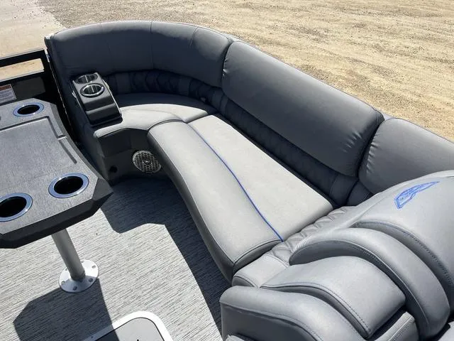 Slide: The Image of 2024 Bennington 25 QFBWA boat interior with gray seating and cup holders. - 14