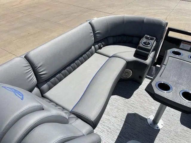 Slide: The Image of 2024 Bennington 25 QFBWA boat interior with gray seating and cup holders. - 15