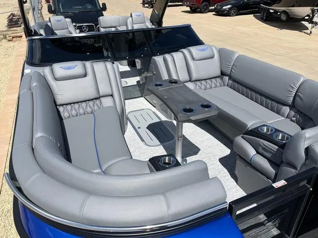 Slide: The Image of 2024 Bennington 25 QFBWA pontoon boat with luxurious gray seating and modern design. - 16