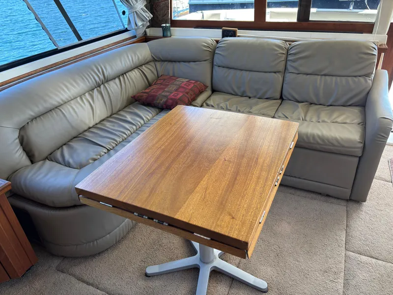 Slide: The Image of Luxurious 1994 Bayliner 4700 yacht interior with leather seating and wooden table. - 18