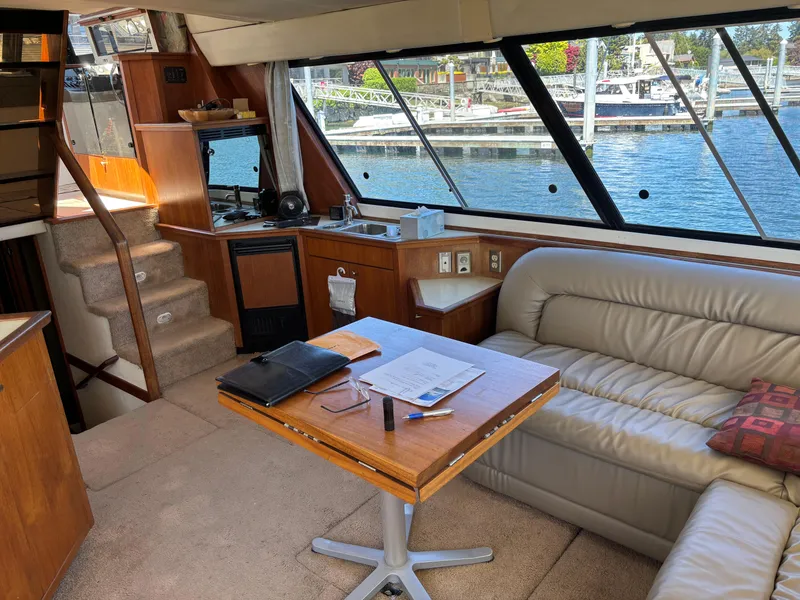 Slide: The Image of Luxurious interior of a 1994 Bayliner 4700 yacht with leather seating and waterfront view. - 19
