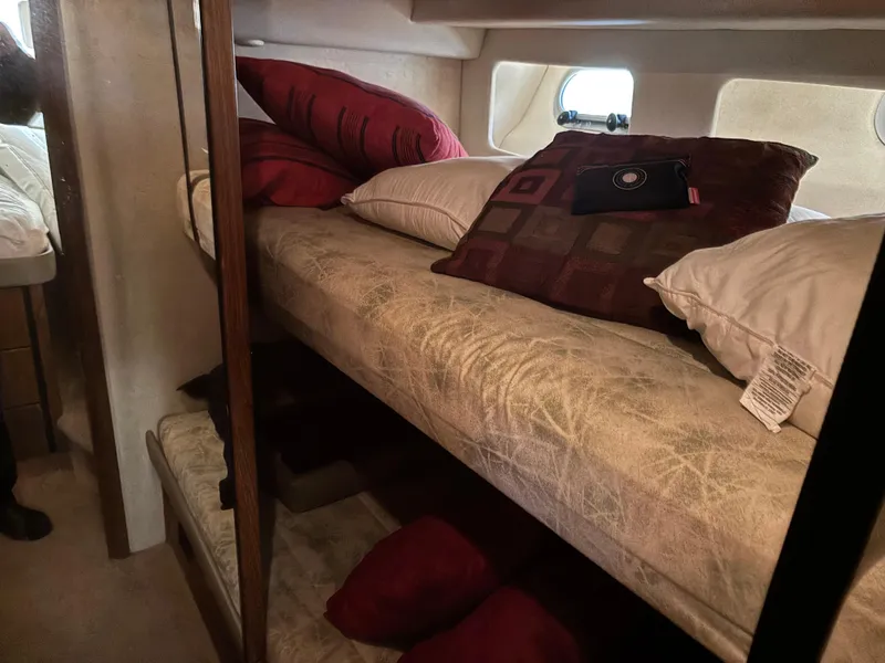 Slide: The Image of Bunk beds in 1994 Bayliner 4700 yacht cabin with pillows and small window. - 22