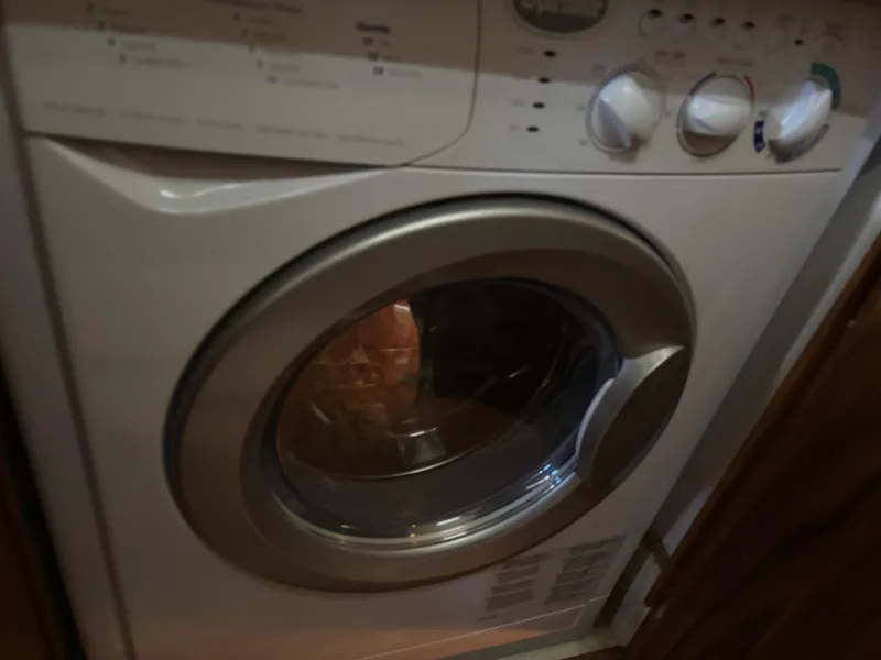 Slide: The Image of Front-loading washing machine with control knobs, inside a Bayliner 4700 yacht, 1994 model. - 24