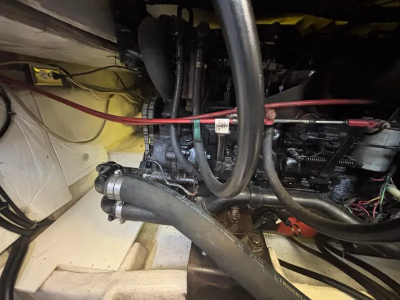 Slide: The Image of Engine compartment of a 1994 Bayliner 4700 boat, showcasing hoses and mechanical components. - 26