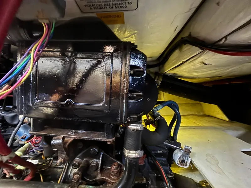 Slide: The Image of Engine compartment of a 1994 Bayliner 4700 boat, showing wiring and mechanical components. - 29