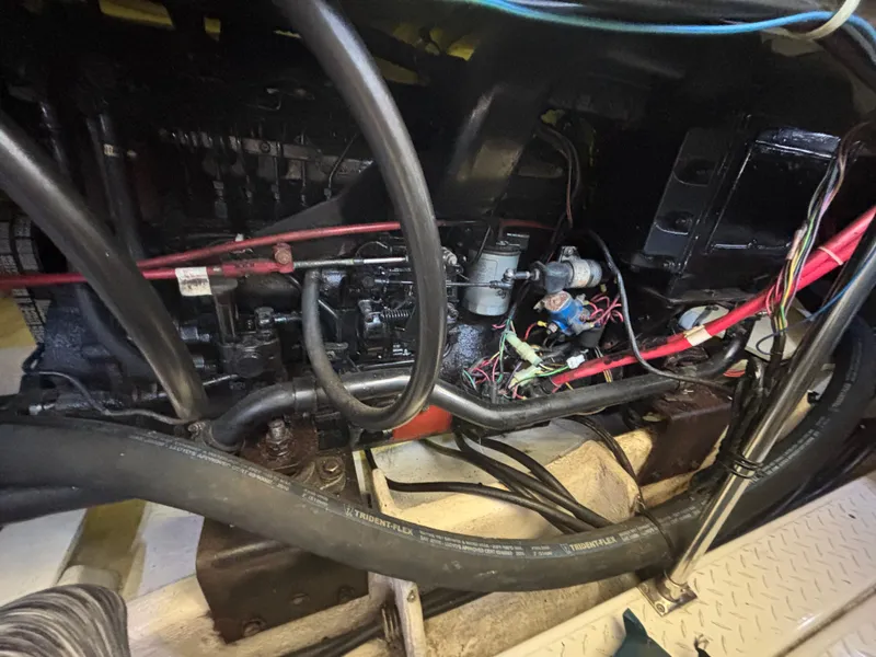 Slide: The Image of Engine compartment of a 1994 Bayliner 4700, showing wiring and mechanical components. - 31