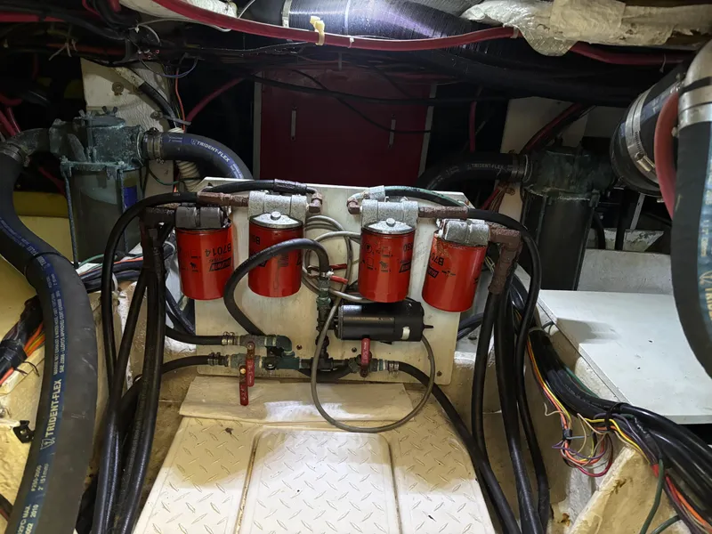 Slide: The Image of Engine room of a 1994 Bayliner 4700 with visible filters and hoses. - 33