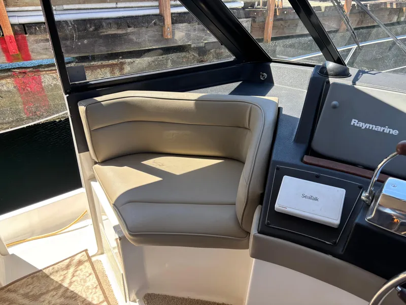 Slide: The Image of Captain's seat on a 1994 Bayliner 4700 yacht, featuring Raymarine navigation equipment. - 9
