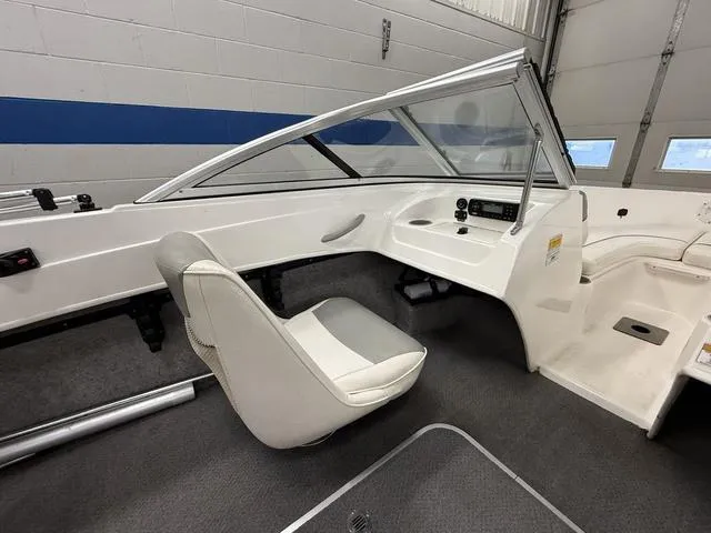 Slide: The Image of Interior of a 2012 Bayliner 170SF boat with seating and control panel. - 10