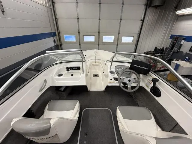 Slide: The Image of Interior view of a 2012 Bayliner 170SF boat, featuring steering wheel and seating. - 11