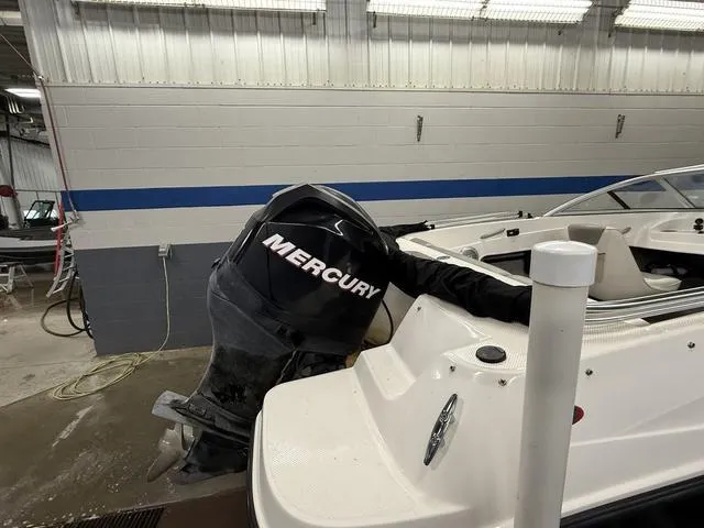 Slide: The Image of 2012 Bayliner 170SF boat with Mercury outboard motor in a garage setting. - 4