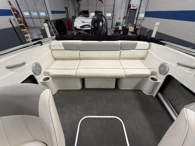 Slide: The Image of 2012 Bayliner 170SF boat interior with white seating and gray accents in a garage setting. - 6