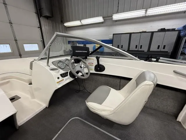 Slide: The Image of Interior of a 2012 Bayliner 170SF boat with steering wheel and dashboard. - 8
