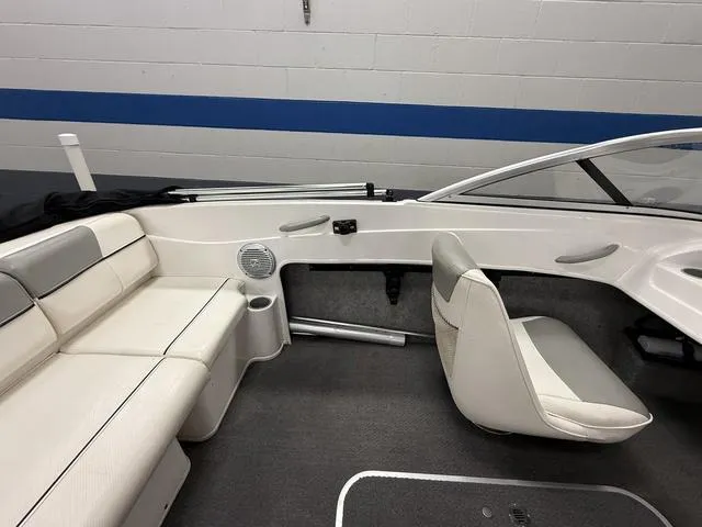 Slide: The Image of Interior of a 2012 Bayliner 170SF boat with white seating and modern design. - 9