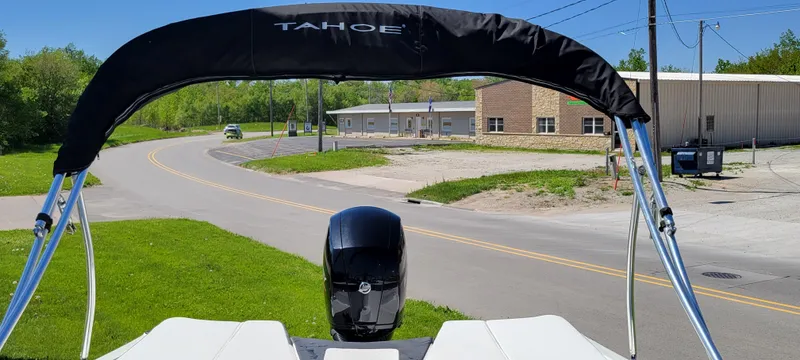 Slide: The Image of 2021 Bass Tracker TAHOE 550TF boat with canopy on a sunny road. - 10