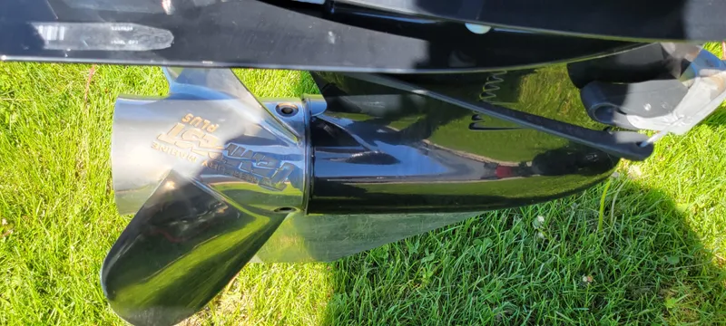Slide: The Image of 2021 Bass Tracker TAHOE 550TF boat propeller on grass, showcasing sleek design. - 13