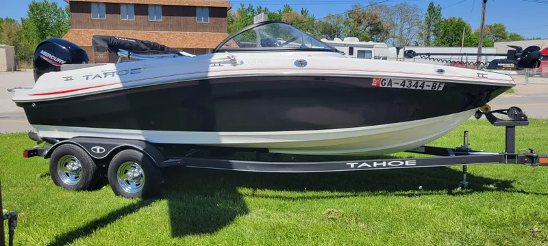 Slide: The Image of 2021 Bass Tracker TAHOE 550TF boat on trailer, parked on grass. - 19