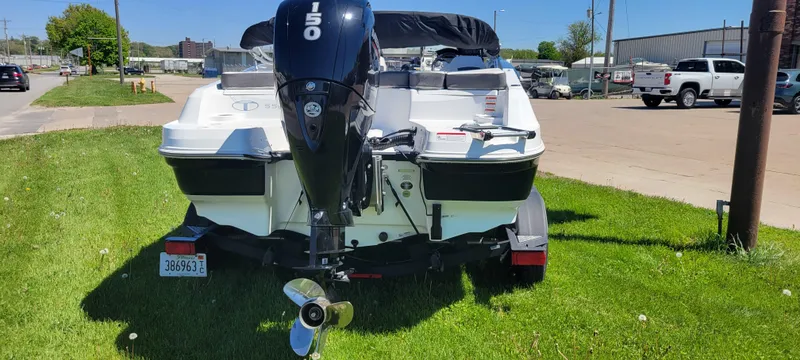 Slide: The Image of 2021 Bass Tracker TAHOE 550TF boat with outboard motor, parked on grass. - 23