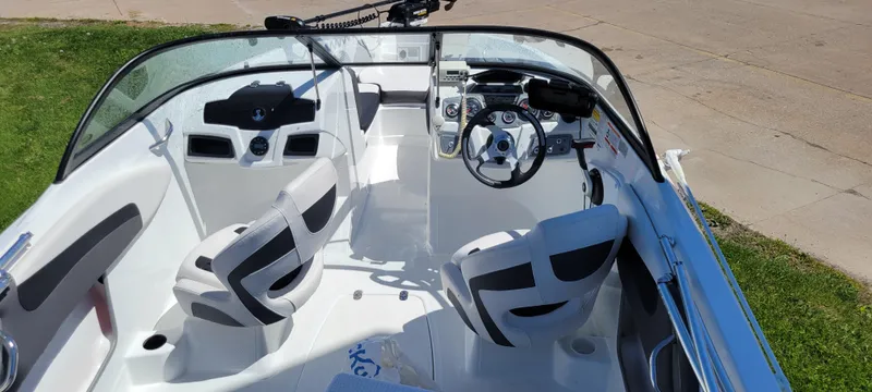 Slide: The Image of 2021 Bass Tracker TAHOE 550TF boat interior with steering wheel and seating. - 28