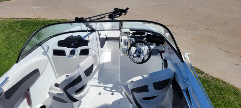 Slide: The Image of 2021 Bass Tracker TAHOE 550TF boat interior with steering wheel and seating. - 29