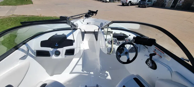 Slide: The Image of 2021 Bass Tracker TAHOE 550TF boat interior with steering wheel and dashboard controls. - 3