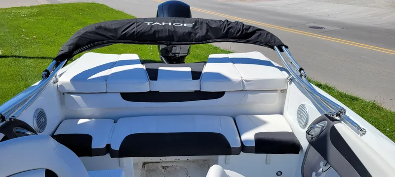 Slide: The Image of 2021 Bass Tracker TAHOE 550TF boat interior with white seating and black accents. - 30