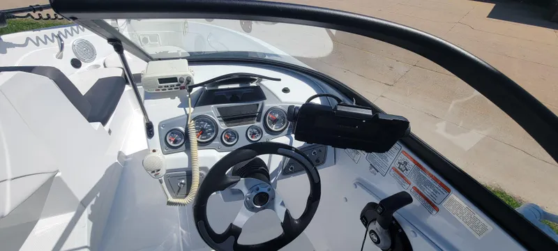 Slide: The Image of 2021 Bass Tracker TAHOE 550TF boat dashboard with steering wheel and gauges. - 39
