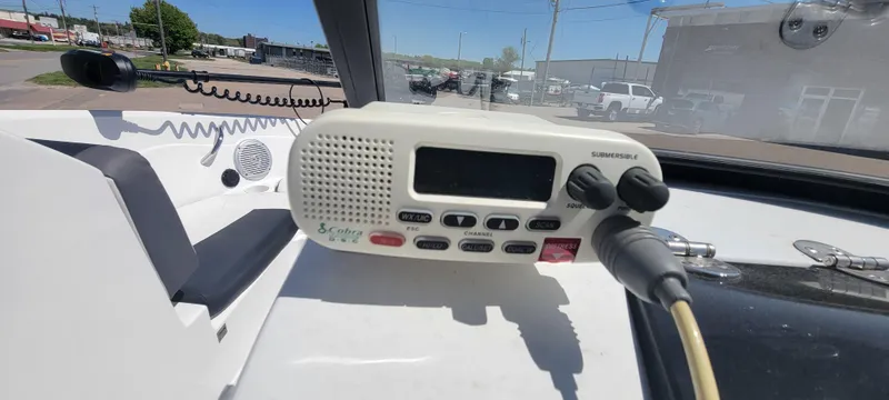 Slide: The Image of 2021 Bass Tracker TAHOE 550TF boat dashboard with marine radio and controls. - 41