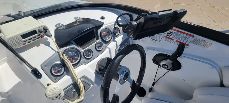 Slide: The Image of 2021 Bass Tracker TAHOE 550TF boat dashboard with steering wheel and control panel. - 42