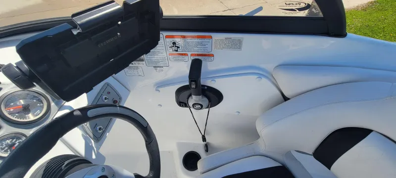 Slide: The Image of 2021 Bass Tracker TAHOE 550TF boat interior with steering wheel and control panel. - 43