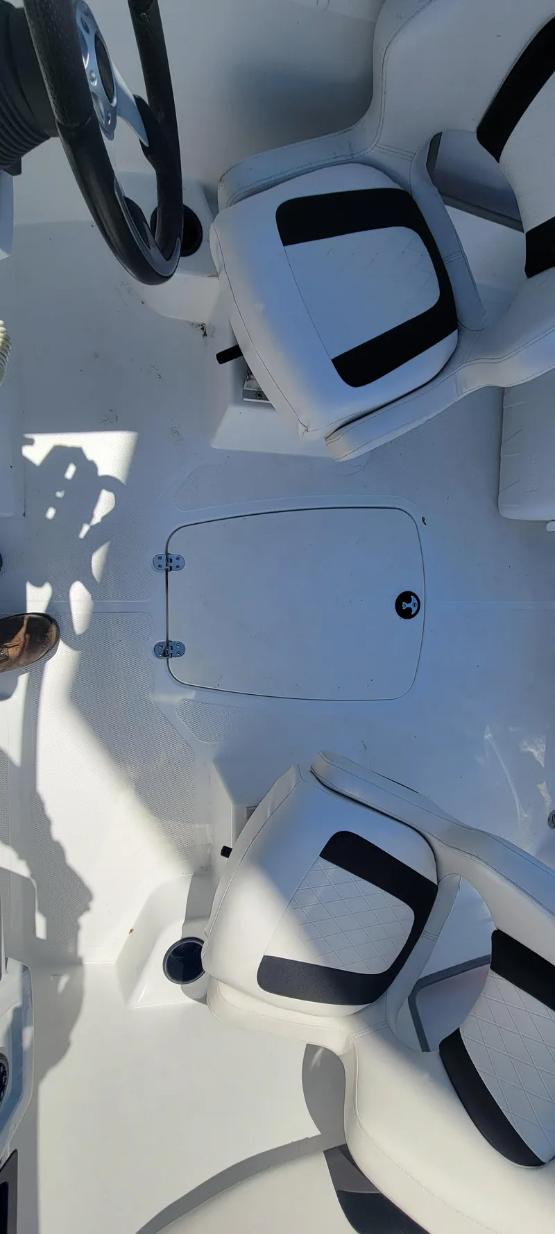 Slide: The Image of 2021 Bass Tracker TAHOE 550TF boat interior with white and black seating. - 46