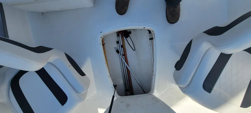 Slide: The Image of 2021 Bass Tracker TAHOE 550TF boat interior with open storage compartment and seating. - 47