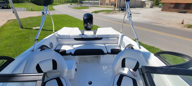Slide: The Image of 2021 Bass Tracker TAHOE 550TF boat interior with white seating and black accents. - 49