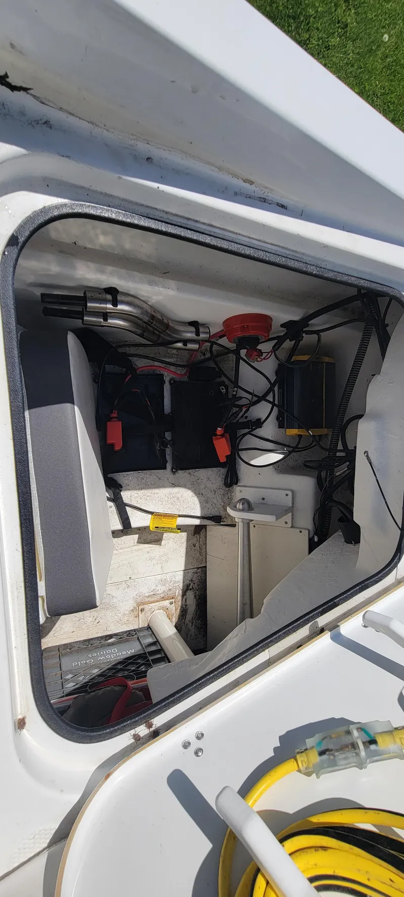 Slide: The Image of 2021 Bass Tracker TAHOE 550TF boat storage compartment with equipment and wiring. - 7