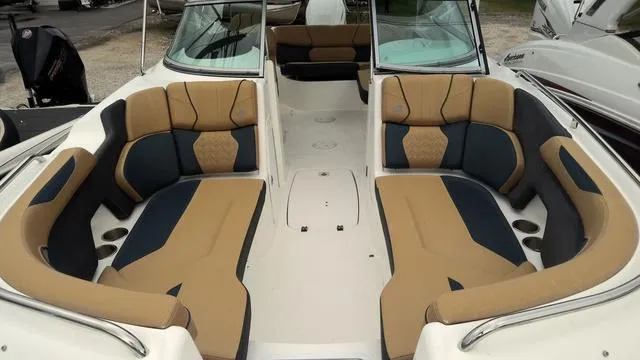 Slide: The Image of 2022 Hurricane Sundeck 2200 OB boat interior with tan and navy seating. - 3