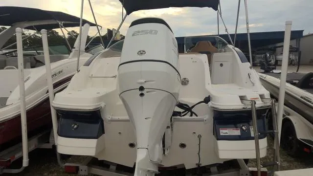 Slide: The Image of 2022 Hurricane Sundeck 2200 OB boat with powerful outboard motor, docked at marina. - 4