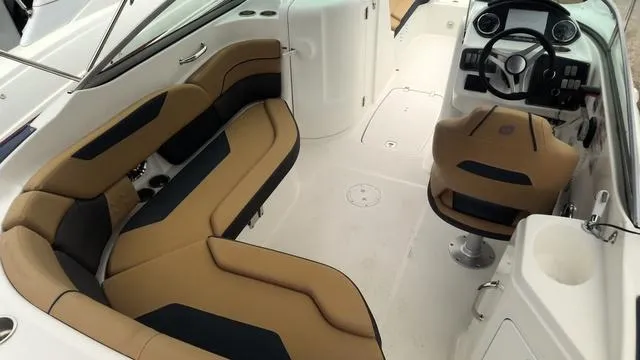 Slide: The Image of 2022 Hurricane Sundeck 2200 OB interior with tan and black seating, modern dashboard. - 5
