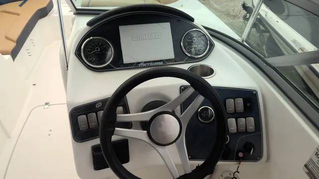Slide: The Image of 2022 Hurricane Sundeck 2200 OB boat dashboard with steering wheel and control panel. - 6