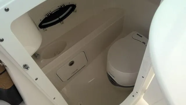 Slide: The Image of 2022 Hurricane Sundeck 2200 OB boat interior with compact marine toilet. - 7
