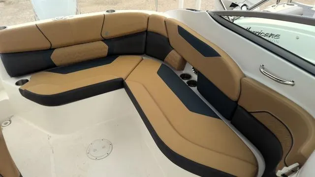 Slide: The Image of 2022 Hurricane Sundeck 2200 OB boat interior with tan and black seating. - 8