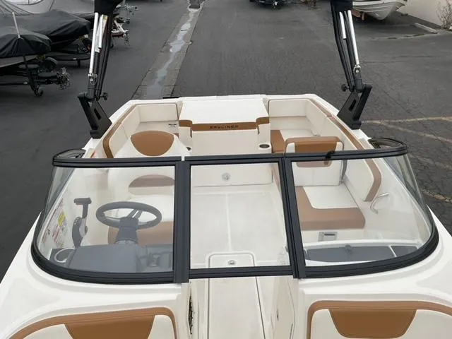 Slide: The Image of 2020 Bayliner VR4 Bowrider I/O with tan and white interior, docked on pavement. - 11