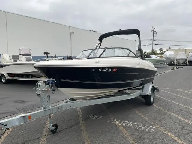 Slide: The Image of 2020 Bayliner VR4 Bowrider I/O on trailer in parking lot, overcast sky. - 3