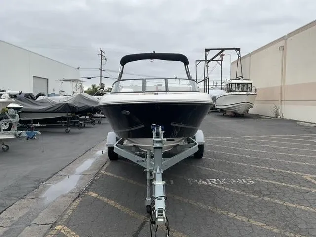 Slide: The Image of 2020 Bayliner VR4 Bowrider I/O on trailer in a boatyard, overcast sky. - 4